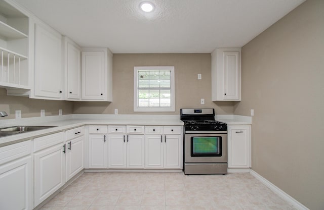 2020 Vince St, Pasadena, TX 77502 - kitchen with gas stove, a sink, light countertops, and open shelves