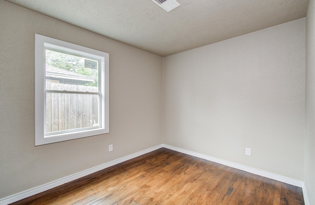 2020 Vince St, Pasadena, TX 77502 - unfurnished room featuring wood finished floors, baseboards, and a textured ceiling
