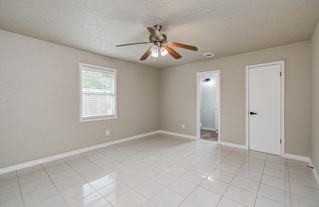 2020 Vince St, Pasadena, TX 77502 - unfurnished room with ceiling fan, a textured ceiling, baseboards, and light tile patterned floors