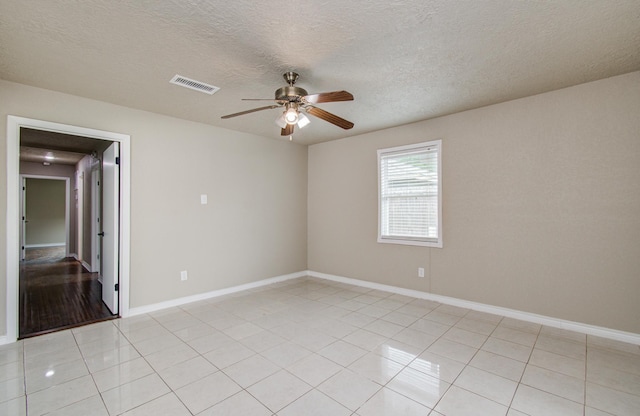2020 Vince St, Pasadena, TX 77502 - empty room with a ceiling fan, baseboards, light tile patterned floors, and a textured ceiling