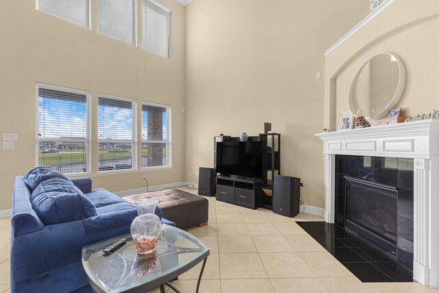 26010 Pagemill Ln, Richmond, TX 77406 - living room with a high ceiling, baseboards, tile patterned floors, and a tiled fireplace
