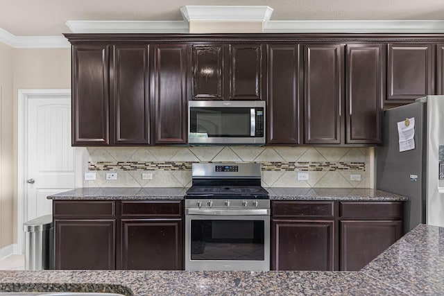 26010 Pagemill Ln, Richmond, TX 77406 - kitchen with appliances with stainless steel finishes, ornamental molding, dark stone countertops, tasteful backsplash, and dark brown cabinetry