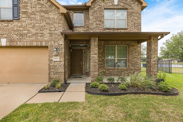 26010 Pagemill Ln, Richmond, TX 77406 - view of front of house featuring brick siding, a porch, and driveway