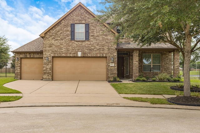26010 Pagemill Ln, Richmond, TX 77406 - traditional-style house featuring concrete driveway, brick siding, and roof with shingles