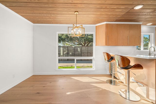 5747 Jackwood St, Houston, TX 77096 - dining space featuring wood ceiling, a chandelier, baseboards, ornamental molding, and light wood-style flooring