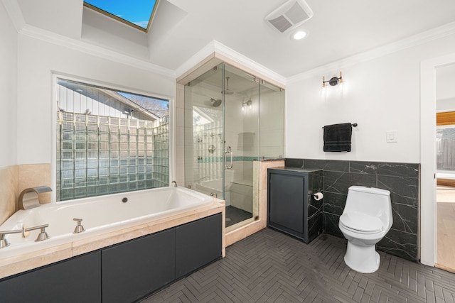 5747 Jackwood St, Houston, TX 77096 - bathroom featuring tile walls, a garden tub, toilet, a shower stall, and a wainscoted wall