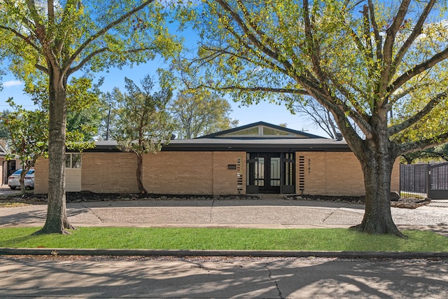 5747 Jackwood St, Houston, TX 77096 - view of front facade featuring brick siding and french doors