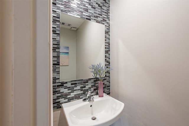 4611 Wolverhampton Way, Missouri City, TX 77459 - bathroom featuring a sink, decorative backsplash, and tile walls