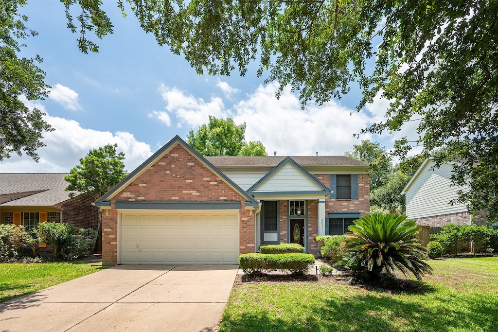 4611 Wolverhampton Way, Missouri City, TX 77459 - view of front of property with brick siding, concrete driveway, an attached garage, and a front lawn