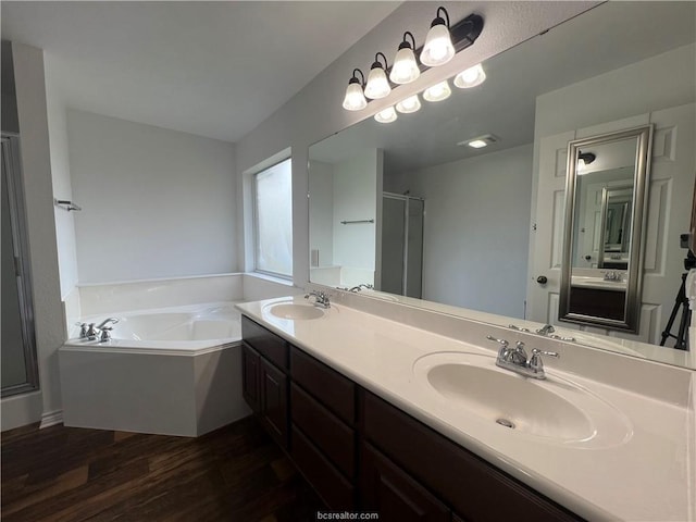 1027 Emerald Dove Ave, College Station, TX 77845 - full bath with a garden tub, wood finished floors, double vanity, and a shower stall
