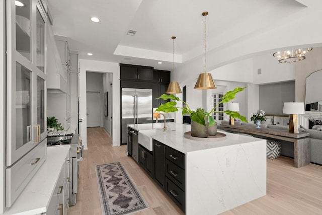 1902 Kessler Point Pl, Katy, TX 77493 - kitchen with a sink, dark cabinets, high quality appliances, light wood-style flooring, and recessed lighting