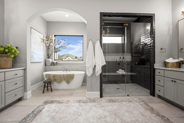 1902 Kessler Point Pl, Katy, TX 77493 - full bath with vanity, a soaking tub, a stall shower, baseboards, and tile patterned floors