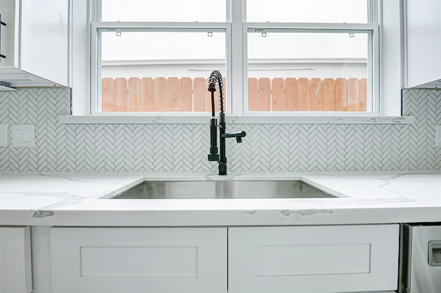 1913 Hoskins Dr Unit F, Houston, TX 77080 - kitchen with decorative backsplash, a sink, and white cabinets