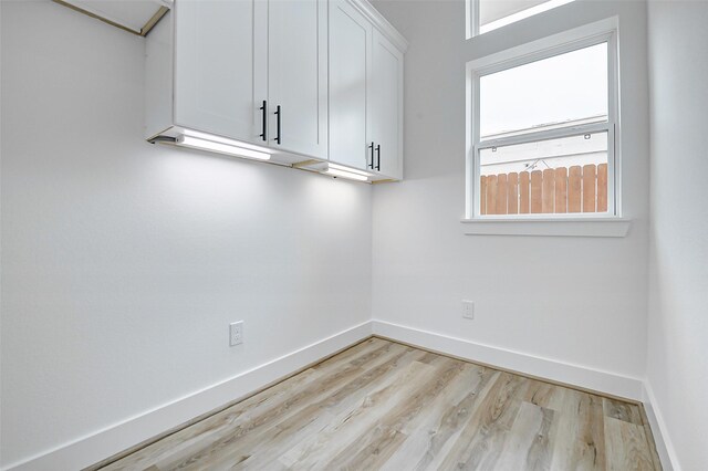 1913 Hoskins Dr Unit F, Houston, TX 77080 - laundry area featuring baseboards and light wood-style flooring