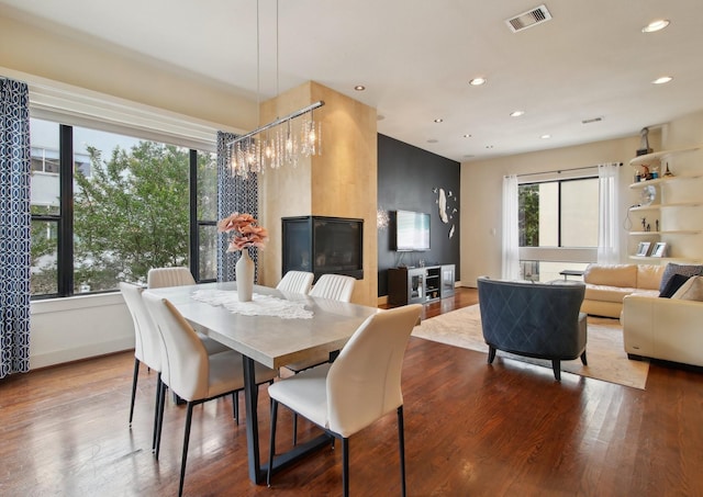 4129 Dickson St, Houston, TX 77007 - dining space featuring recessed lighting, wood finished floors, and a chandelier