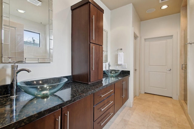 4129 Dickson St, Houston, TX 77007 - bathroom featuring double vanity and tile patterned flooring