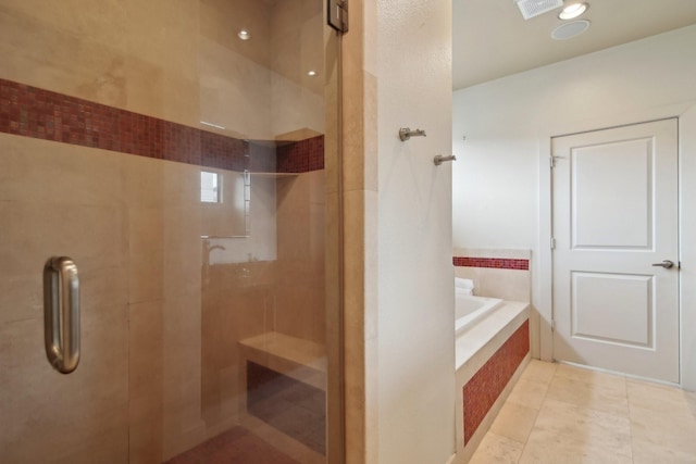 4129 Dickson St, Houston, TX 77007 - bathroom featuring a shower stall, a garden tub, and tile patterned flooring