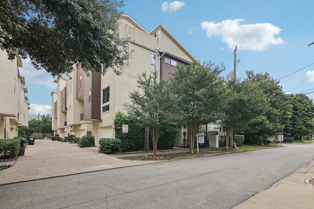 4129 Dickson St, Houston, TX 77007 - view of building exterior with driveway and a garage