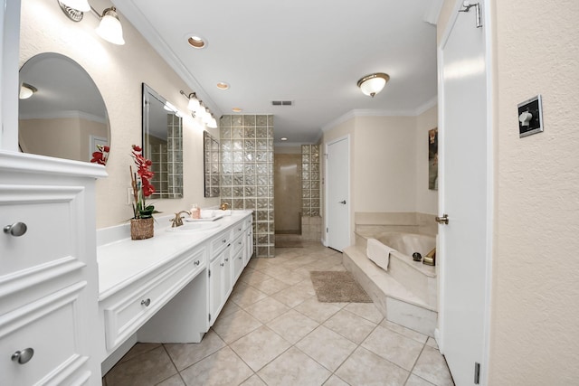 1207 W Edgewood Dr, Friendswood, TX 77546 - full bathroom featuring double vanity, tile patterned floors, a garden tub, crown molding, and recessed lighting