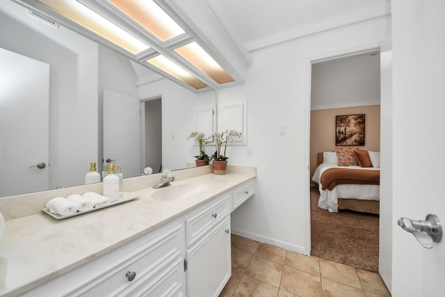 1207 W Edgewood Dr, Friendswood, TX 77546 - bathroom with vanity, tile patterned flooring, ensuite bath, ornamental molding, and baseboards