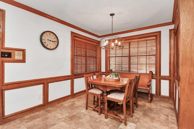1207 W Edgewood Dr, Friendswood, TX 77546 - dining room with a chandelier, ornamental molding, light stone finish flooring, wainscoting, and a decorative wall