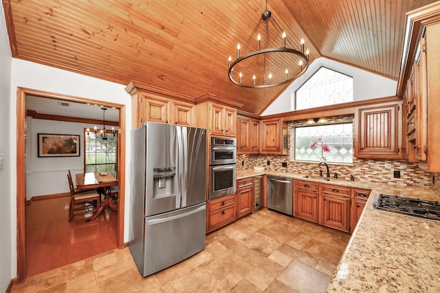 1207 W Edgewood Dr, Friendswood, TX 77546 - kitchen featuring appliances with stainless steel finishes, a chandelier, a sink, plenty of natural light, and lofted ceiling
