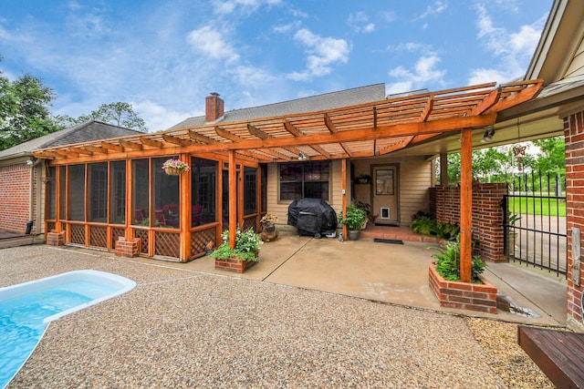 1207 W Edgewood Dr, Friendswood, TX 77546 - back of house featuring a pergola, a chimney, a patio area, and a sunroom