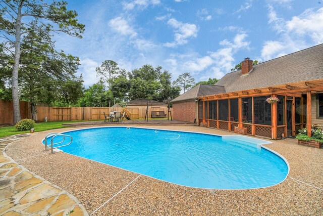 1207 W Edgewood Dr, Friendswood, TX 77546 - view of swimming pool featuring a sunroom and a fenced backyard