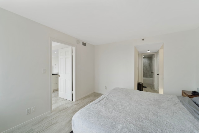 3525 Sage Rd Unit 1104, Houston, TX 77056 - bedroom featuring baseboards and light wood-style floors