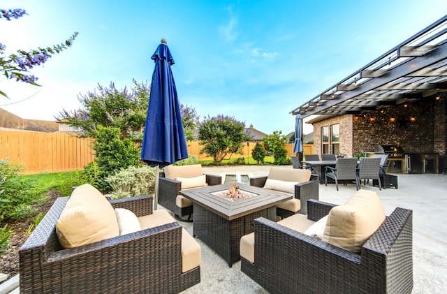 28907 Copper Break Ct, Katy, TX 77494 - fenced backyard with outdoor dining space, an outdoor living space with a fire pit, a patio area, and an outdoor kitchen