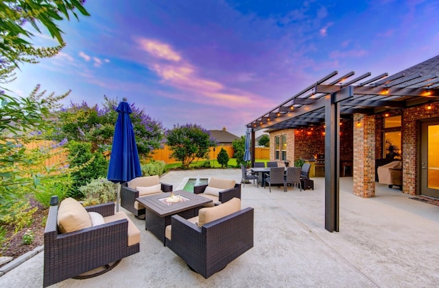 28907 Copper Break Ct, Katy, TX 77494 - patio terrace at dusk featuring a pergola, outdoor dining area, a patio area, and an outdoor living space with a fire pit