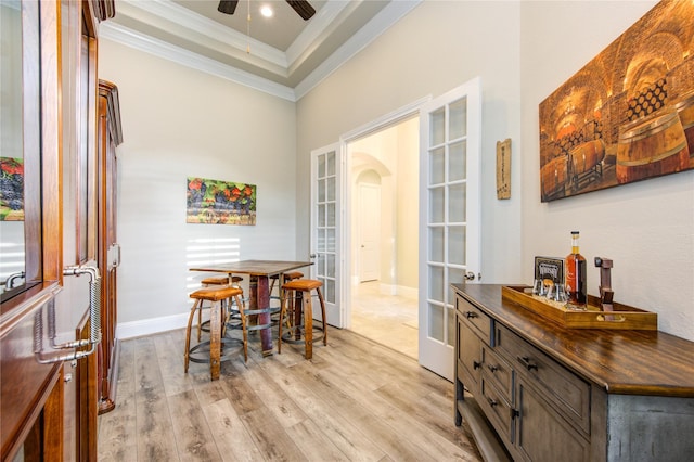 28907 Copper Break Ct, Katy, TX 77494 - dining area featuring ornamental molding, ceiling fan, arched walkways, light wood-style floors, and french doors