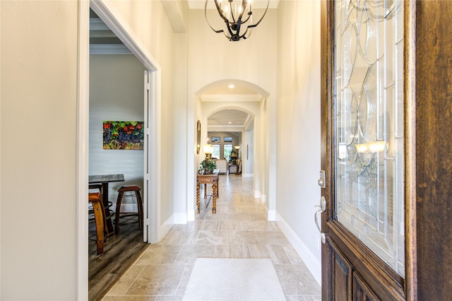 28907 Copper Break Ct, Katy, TX 77494 - foyer entrance featuring arched walkways, a chandelier, baseboards, and ornamental molding
