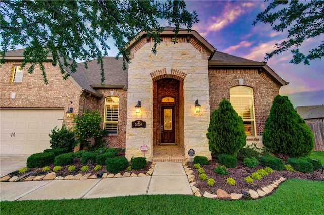 28907 Copper Break Ct, Katy, TX 77494 - view of front facade with roof with shingles, brick siding, a garage, and stone siding