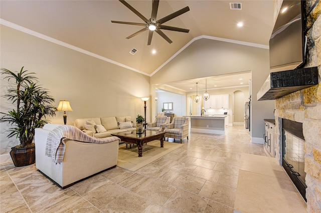 28907 Copper Break Ct, Katy, TX 77494 - living area with ceiling fan, a stone fireplace, recessed lighting, high vaulted ceiling, and ornamental molding