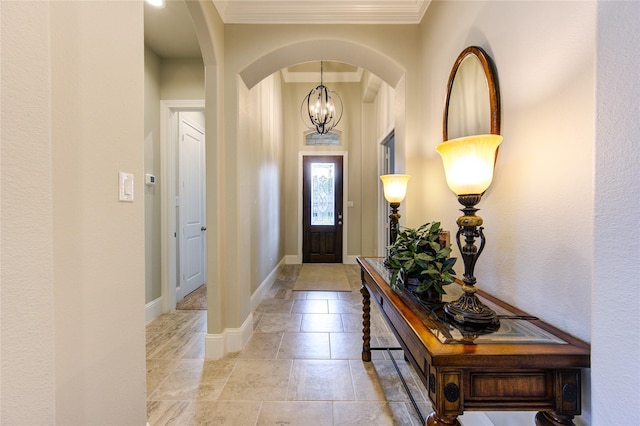 28907 Copper Break Ct, Katy, TX 77494 - foyer with crown molding, arched walkways, baseboards, and a chandelier