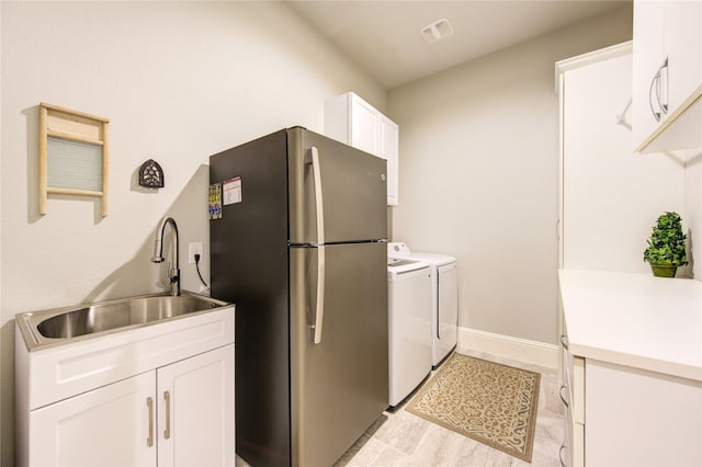 28907 Copper Break Ct, Katy, TX 77494 - kitchen with a sink, freestanding refrigerator, white cabinetry, baseboards, and light countertops