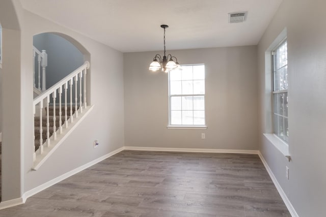 5903 Bonners Park Ct, Katy, TX 77449 - spare room with plenty of natural light, wood finished floors, a chandelier, and stairway
