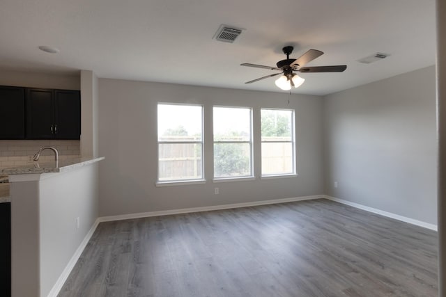 5903 Bonners Park Ct, Katy, TX 77449 - unfurnished living room with light wood-type flooring, ceiling fan, and baseboards