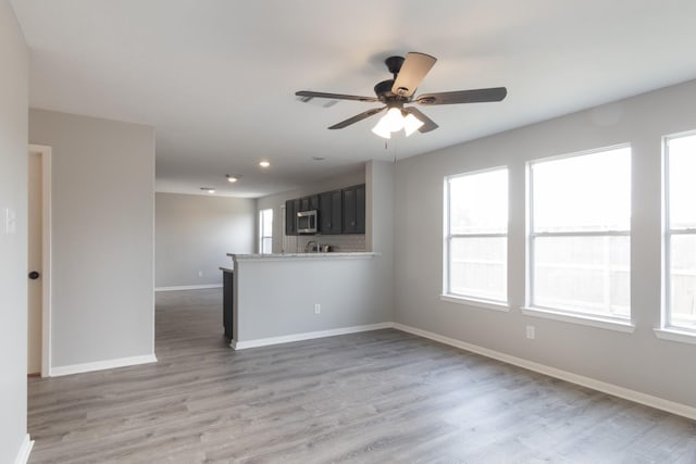 5903 Bonners Park Ct, Katy, TX 77449 - unfurnished living room with ceiling fan, baseboards, light wood-style flooring, and recessed lighting