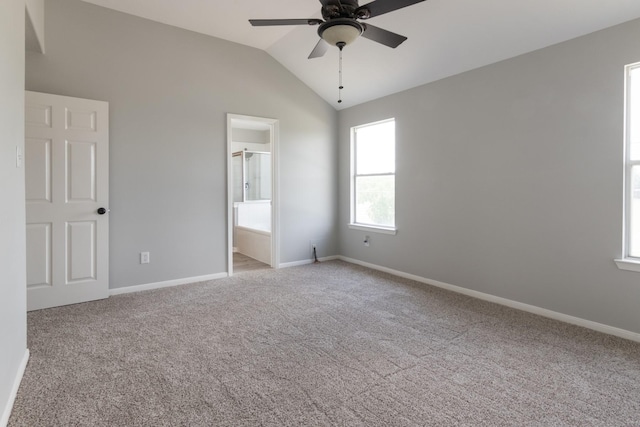 5903 Bonners Park Ct, Katy, TX 77449 - unfurnished bedroom featuring carpet, baseboards, lofted ceiling, ensuite bath, and a ceiling fan