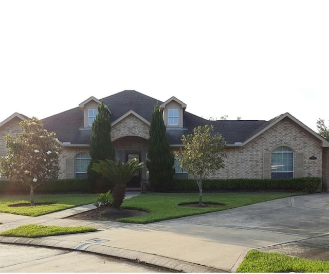 3501 Carson Ct, Pearland, TX 77584 - view of front facade with a front yard and brick siding