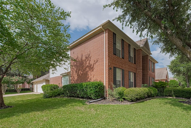11203 Chestnut Woods Trl, Houston, TX 77065 - view of side of property featuring brick siding, a yard, an attached garage, and driveway