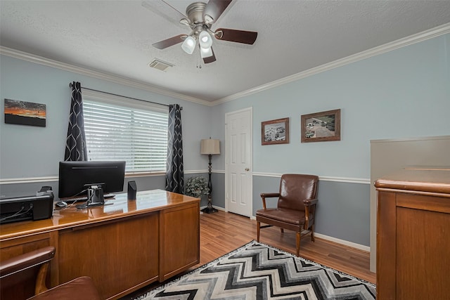 11203 Chestnut Woods Trl, Houston, TX 77065 - home office featuring ceiling fan, light wood-style floors, ornamental molding, a textured ceiling, and baseboards