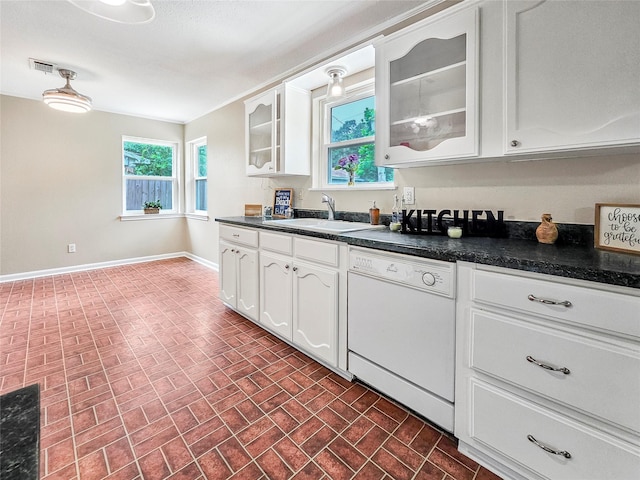 723 Pas Trl, Houston, TX 77336 - kitchen featuring white dishwasher, a sink, brick patterned floors, dark countertops, and baseboards