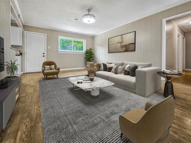723 Pas Trl, Houston, TX 77336 - living room featuring wood finished floors, a textured ceiling, baseboards, and wood walls