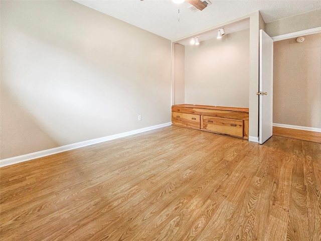 723 Pas Trl, Houston, TX 77336 - empty room with wood finished floors, a ceiling fan, and baseboards