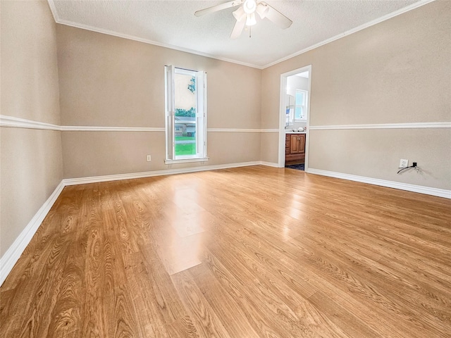 723 Pas Trl, Houston, TX 77336 - spare room with light wood finished floors, ceiling fan, a textured ceiling, baseboards, and crown molding