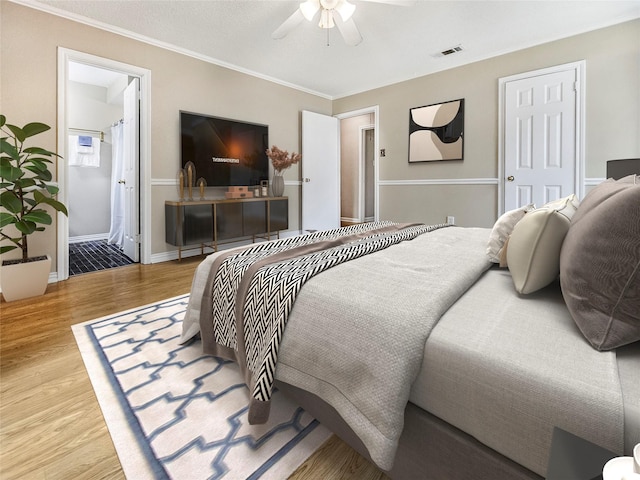 723 Pas Trl, Houston, TX 77336 - bedroom with wood finished floors, crown molding, baseboards, ceiling fan, and ensuite bathroom