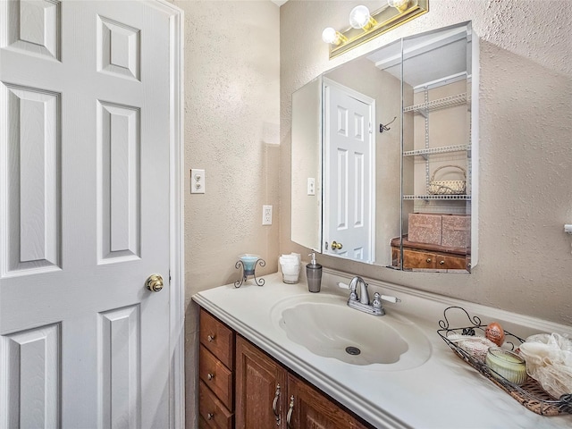 723 Pas Trl, Houston, TX 77336 - bathroom featuring a textured wall and vanity